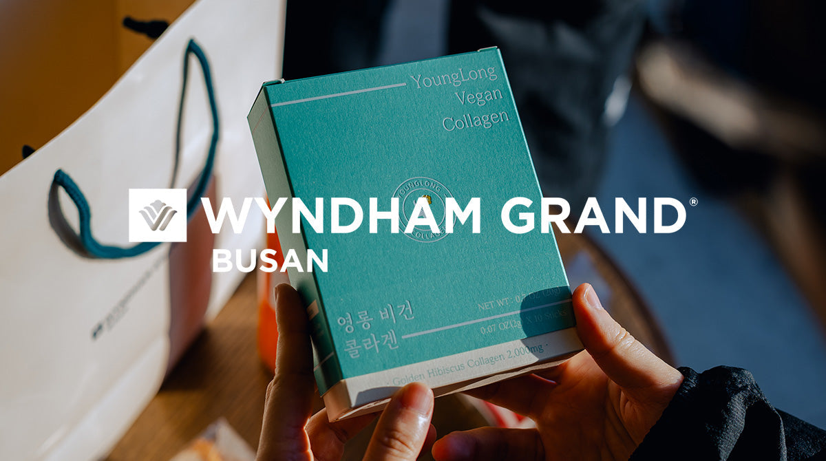 Hands holding a teal YoungLong Vegan Collagen box featuring Golden Hibiscus Collagen 2,000mg, with the Wyndham Grand Busan logo overlaid, symbolizing the brand collaboration at the wellness event.