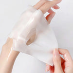 Hands holding a hydrating sheet face mask with eye cutouts, showcasing its texture and fit for skincare routines.