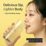 Woman drinking a clear supplement drink for bloating relief with wellness text on yellow background