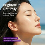 Woman with radiant, glowing skin outdoors by the sea, promoting natural UV protection skincare.