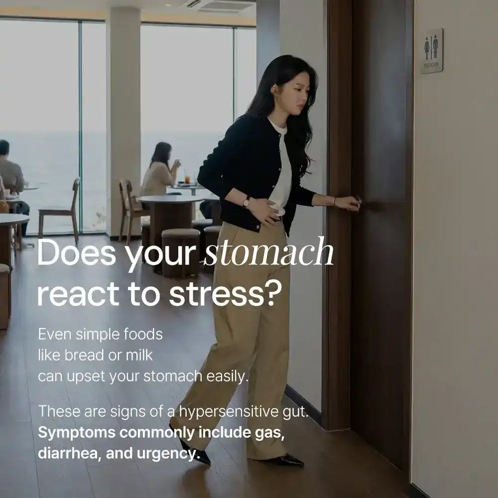 Woman clutching stomach entering restroom in cafe, text about hypersensitive gut symptoms.