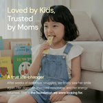 Young girl eating supplement stick pack at home, smiling on sofa, kids health product.