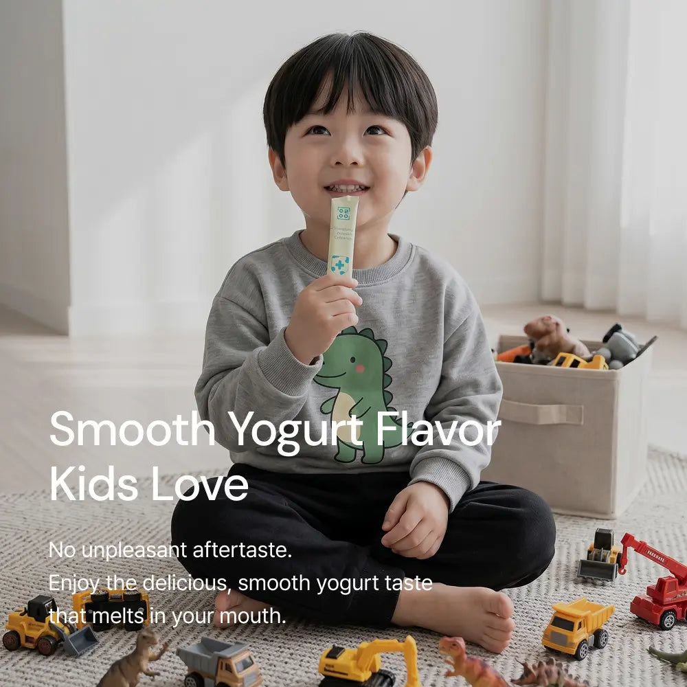 Child enjoying kids yogurt stick, sitting among toys in a bright, cozy room.