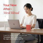 Woman at desk with laptop, supplement box, and glass of water, promoting healthy after-meal ritual.