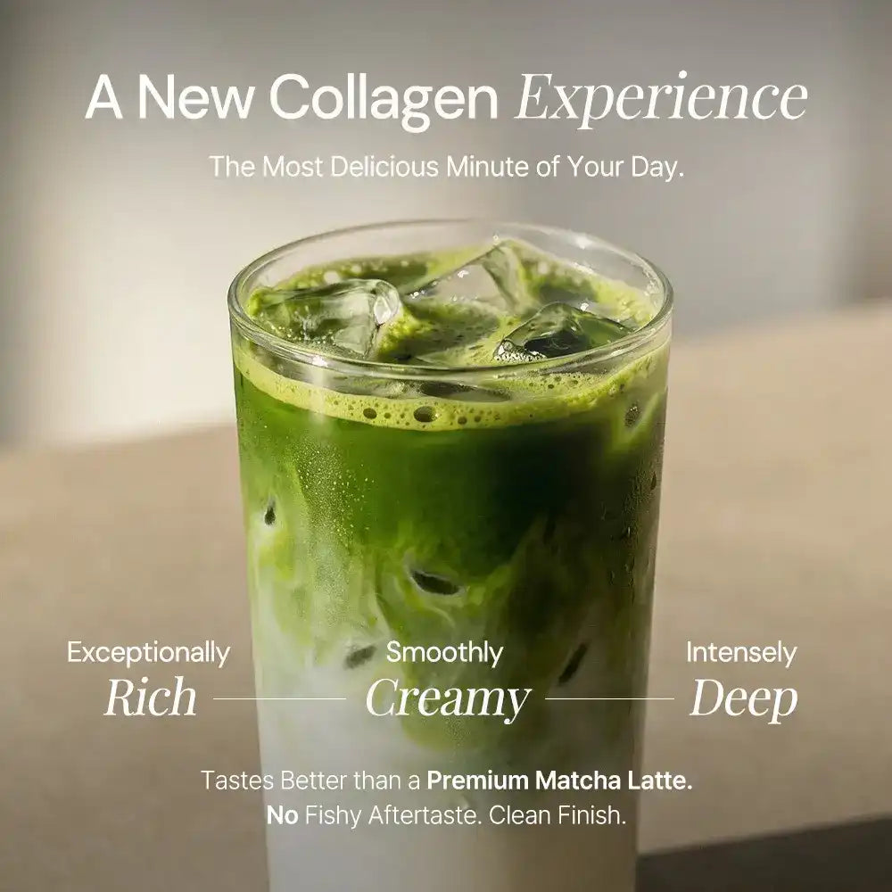Iced collagen matcha latte in a clear glass, layered green and white, with ice cubes on a table.