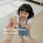 Smiling child in overalls reaching for probiotic supplement stick in a bright home setting